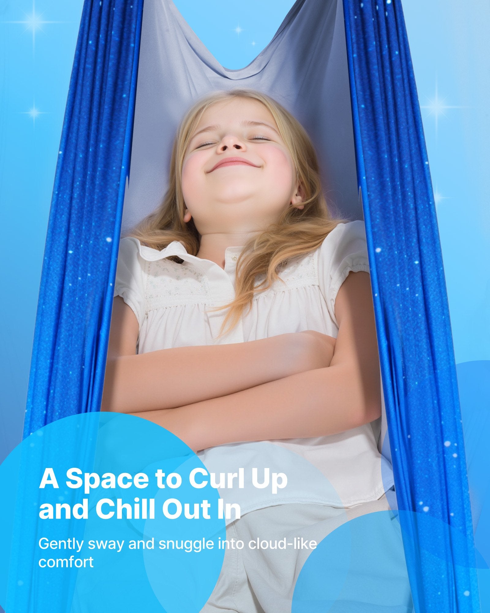 Smiling child relaxing in a blue sensory swing hammock against a calming blue background.