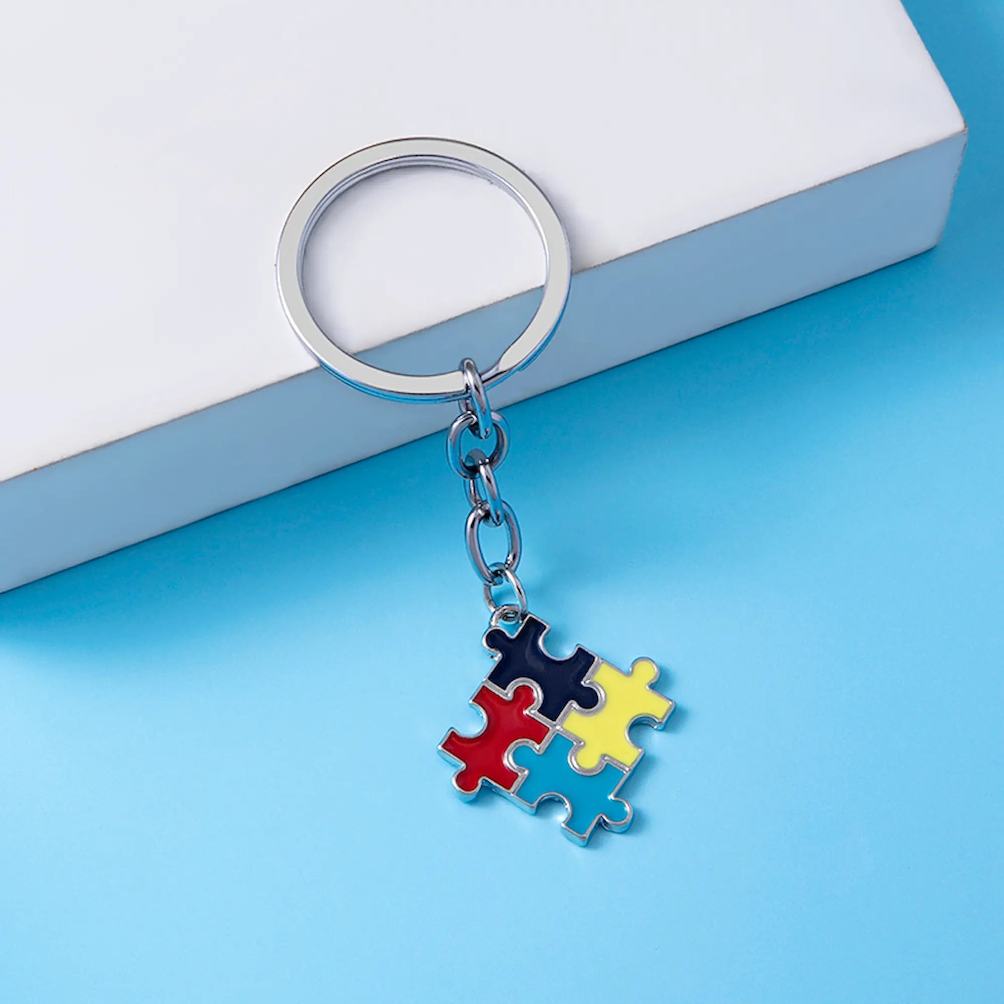 Keychain with puzzle piece design on a blue surface